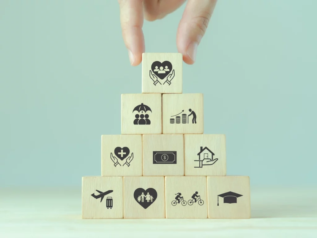 Wooden blocks with Benefits and Expense Management features placed on top of each other